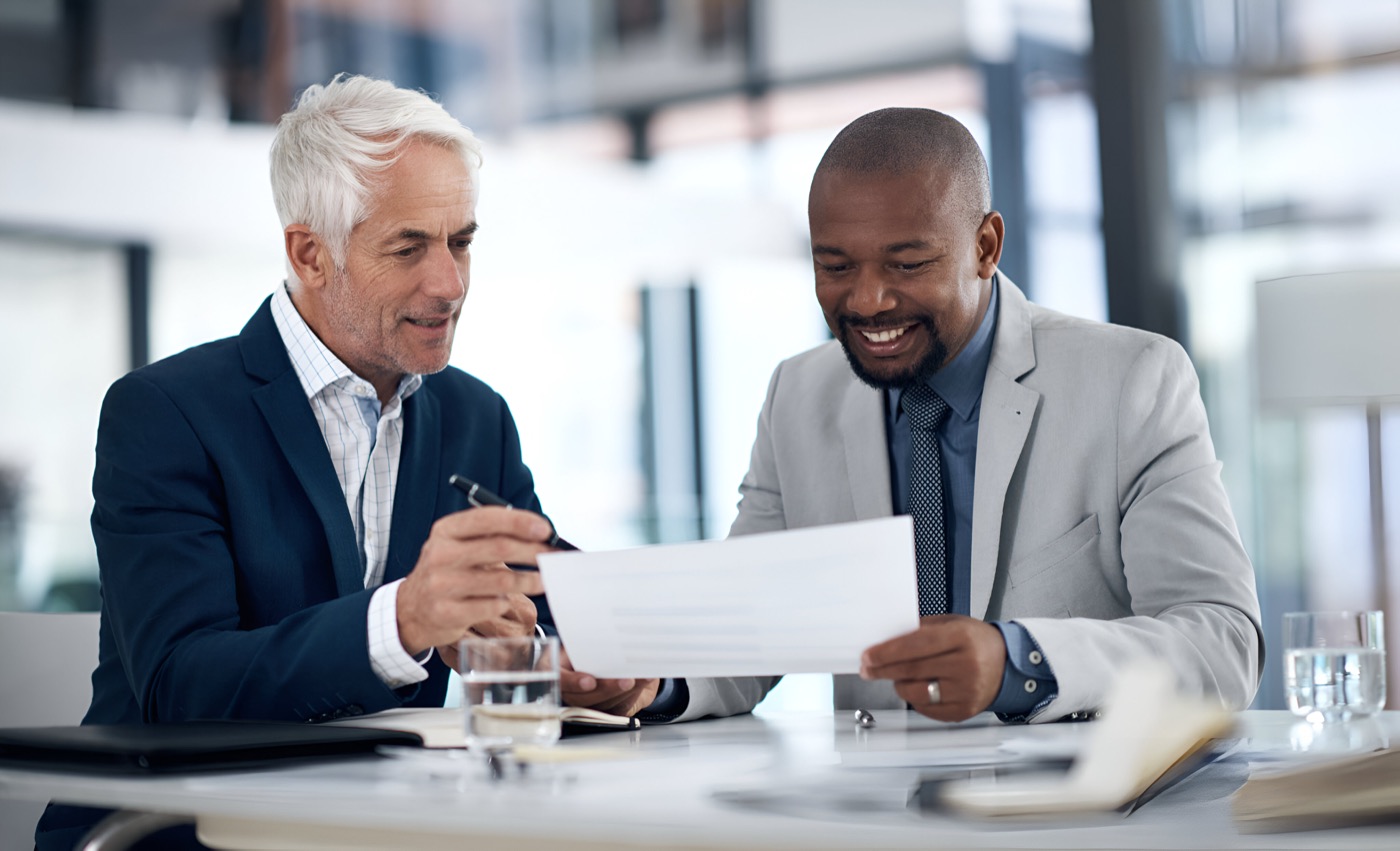 Two corporate colleagues reviewing documents together in an office
